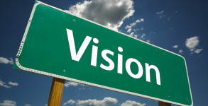 Vision Road Sign with dramatic blue sky and clouds.