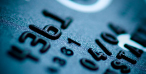teal credit card digits close-up