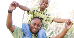 Man and Child Having fun in the park.